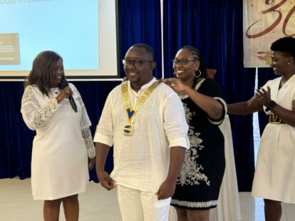 Enous, our chair of board of governors, being installed as Rotary president