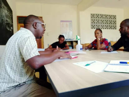 Enos chairing a Board of Governors meeting at the school