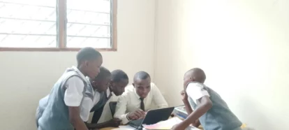 The children examine one of the new laptops